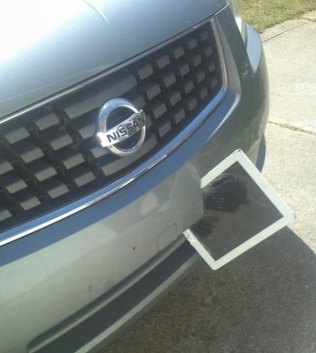 photo of iPad flies off of car roof, wedges itself into another car's bumper image