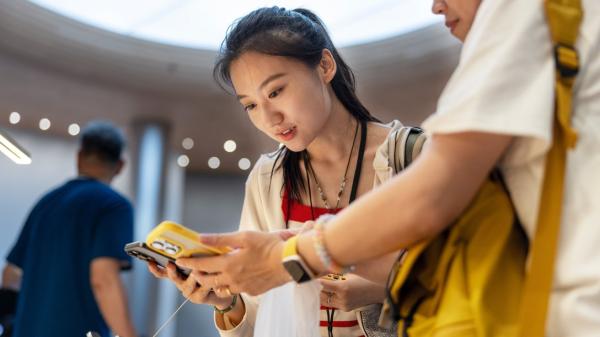 Customers try out the iPhone 16 in Apple…