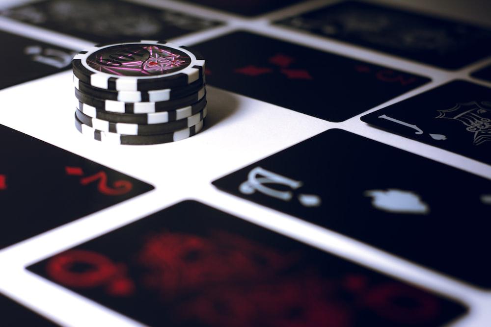 black playing cards and chips