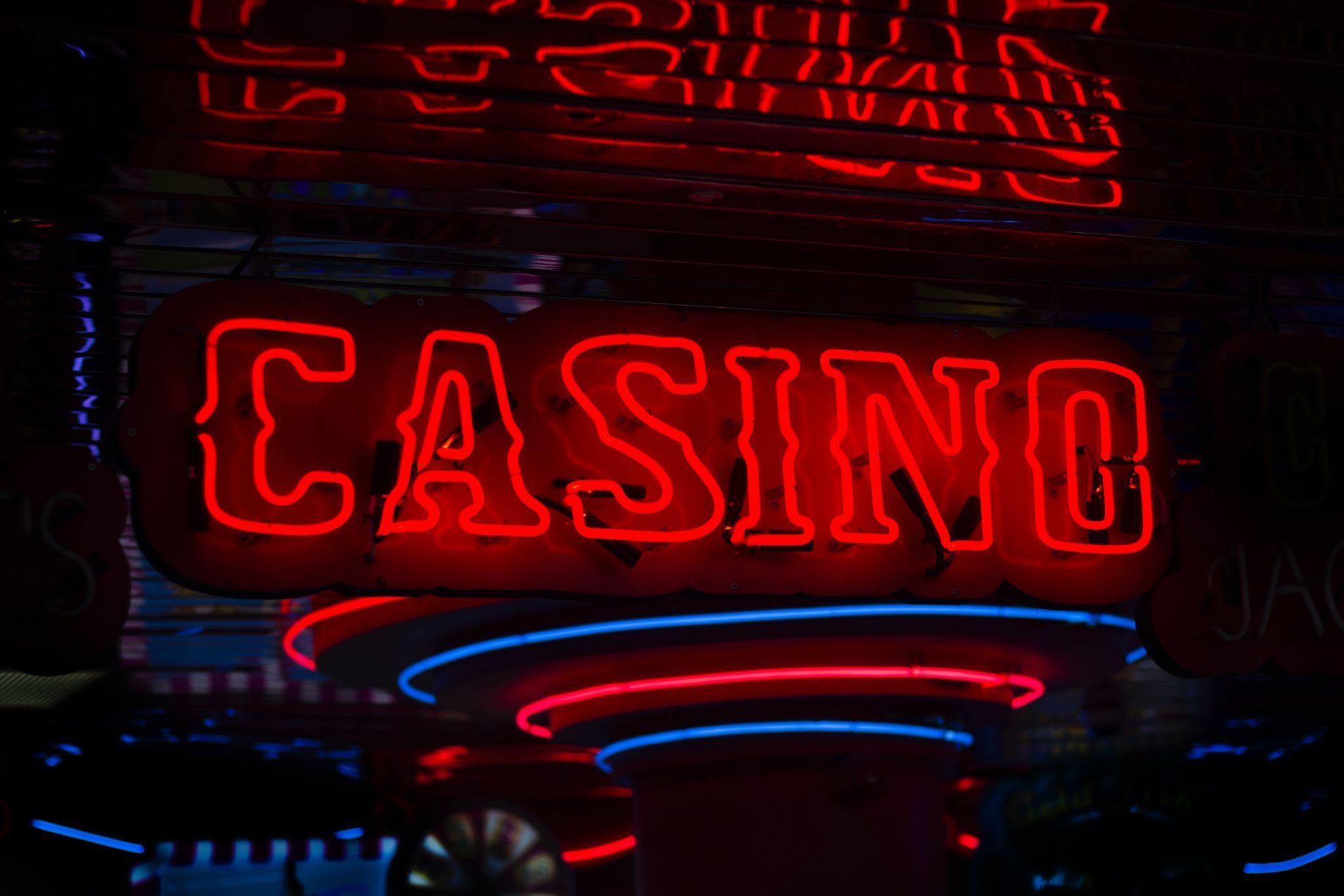 Neon text casino glowing against a dark background