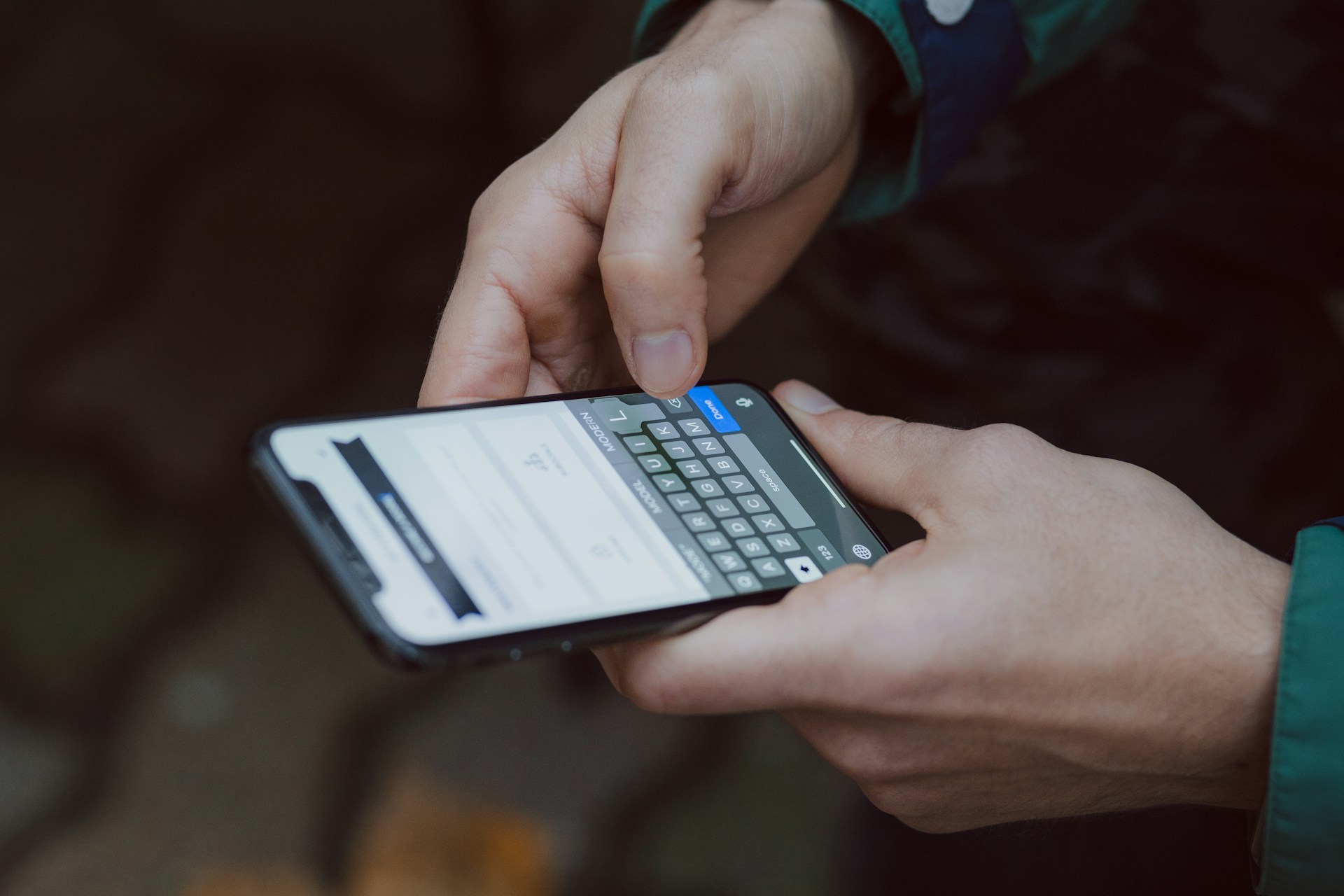 hands holding iPhone typing