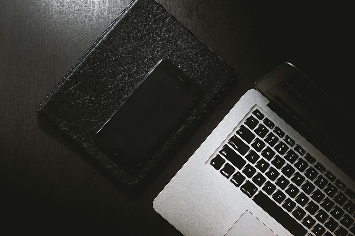 Macbook on leather desk