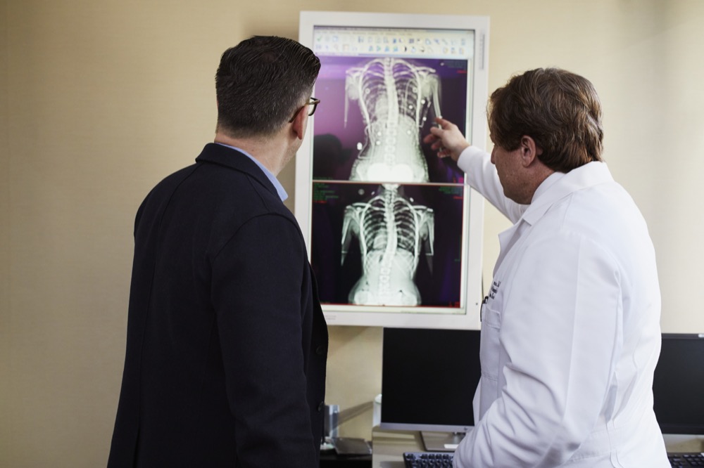 doctors looking at broken bones X-ray