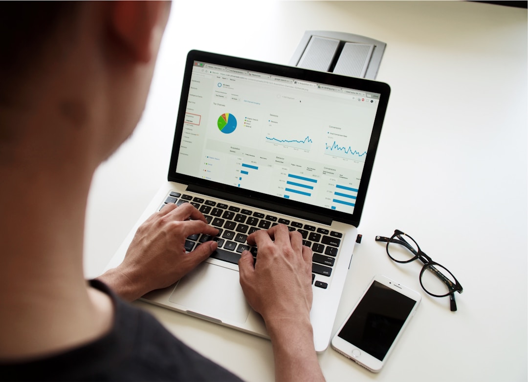 A man using a laptop as a tool for proposal management.